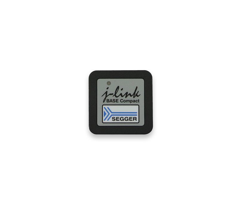 A small square device labeled "j-link BASE Compact" with the SEGGER logo, designed for programming and debugging embedded systems. The background is white, emphasizing the device's details and branding.